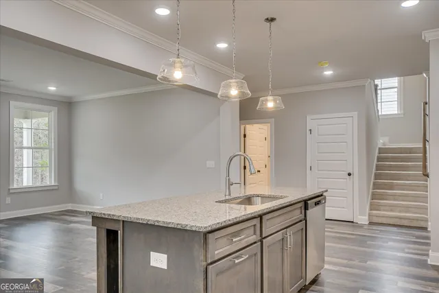 a kitchen with granite countertop a stove and a microwave
