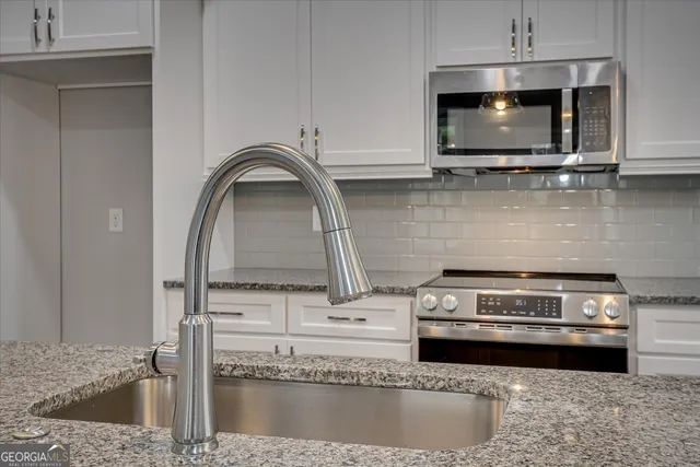 a kitchen with a stove and a microwave