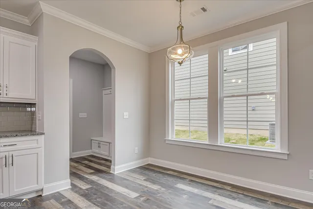 a large kitchen with granite countertop a stove top oven a sink a counter space and cabinets