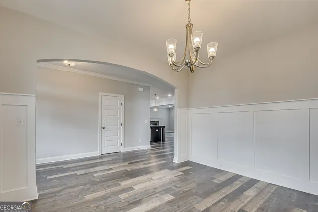 a view of a hallway with wooden floor and entryway