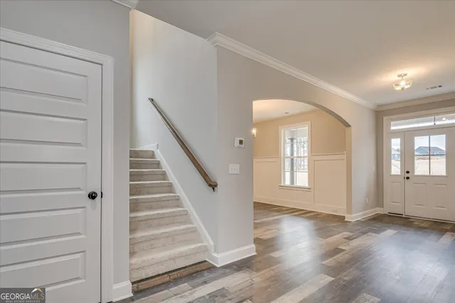 a view of a hallway with a chandelier fan