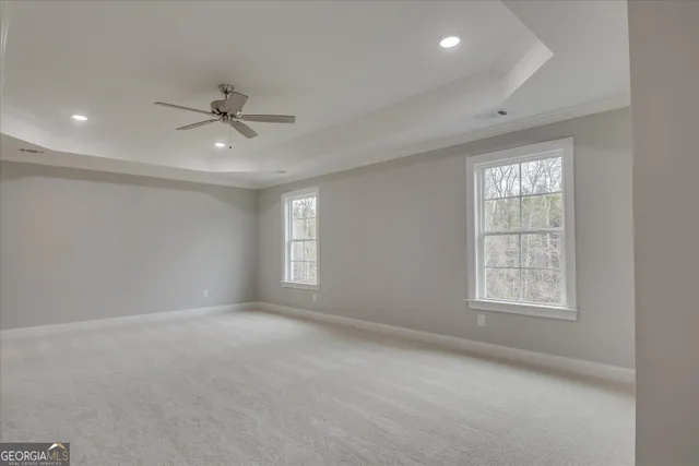 a view of an empty room and a ceiling fan window