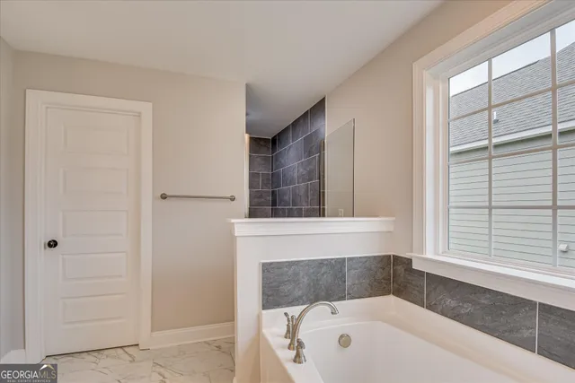 a bathroom with a bathtub and a window