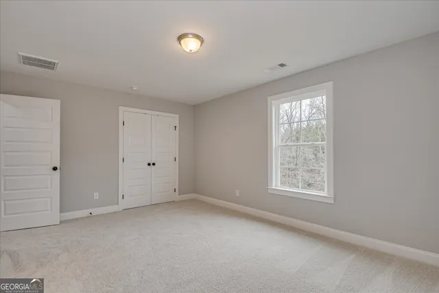 a bathroom with a granite countertop sink toilet mirror and bathtub