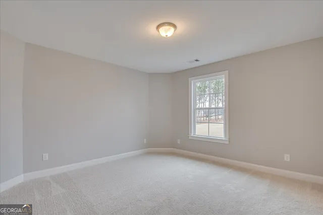 a bathroom with a granite countertop double vanity sink and mirror