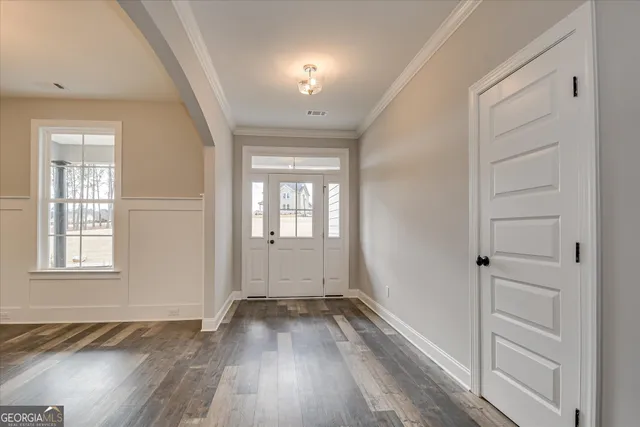a view of empty room with wooden floor