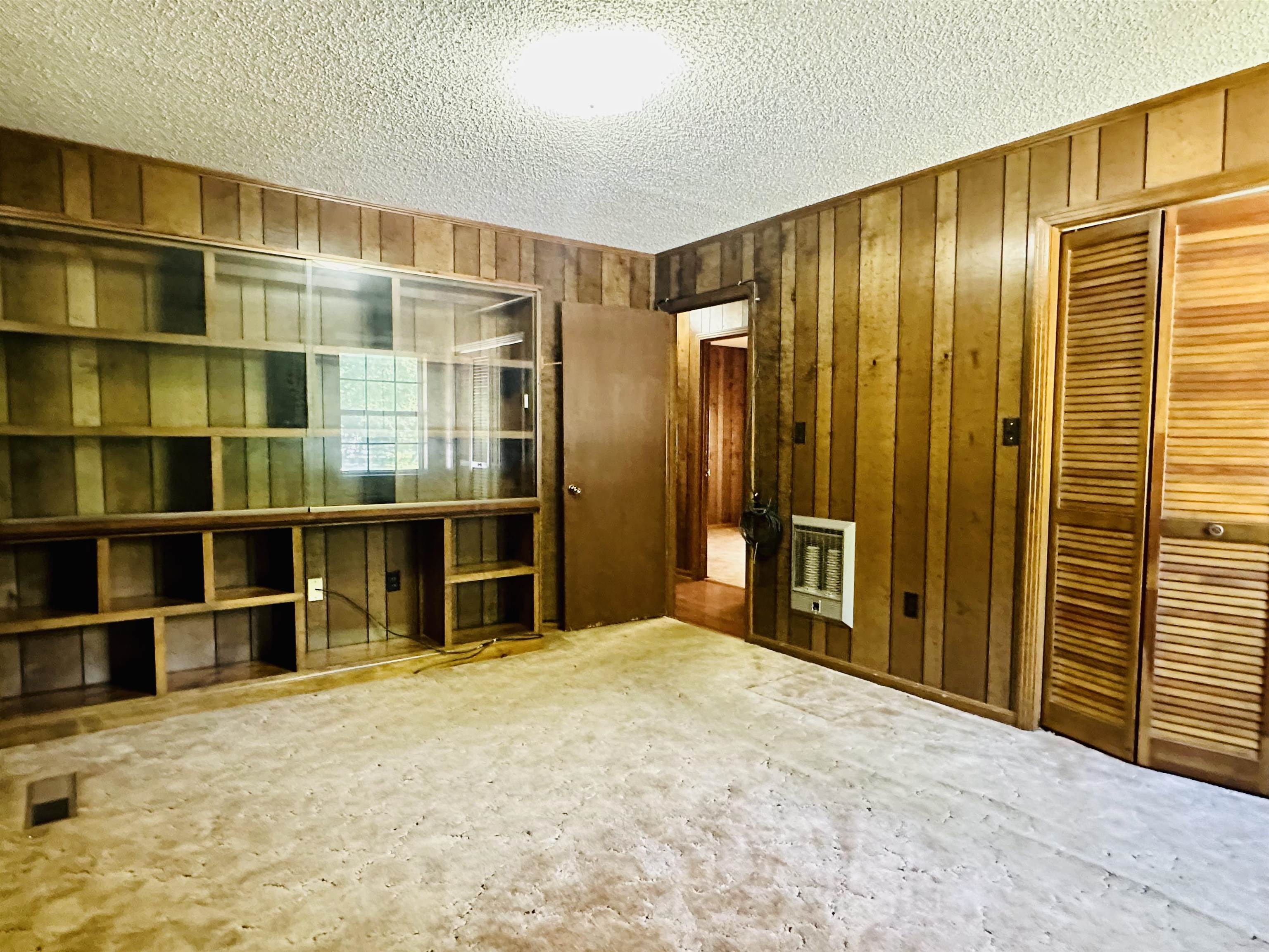 182 Wenasoga Road Ramer, TN 38367 - Photo 12 of 31 a view of an empty room with wooden shelves
