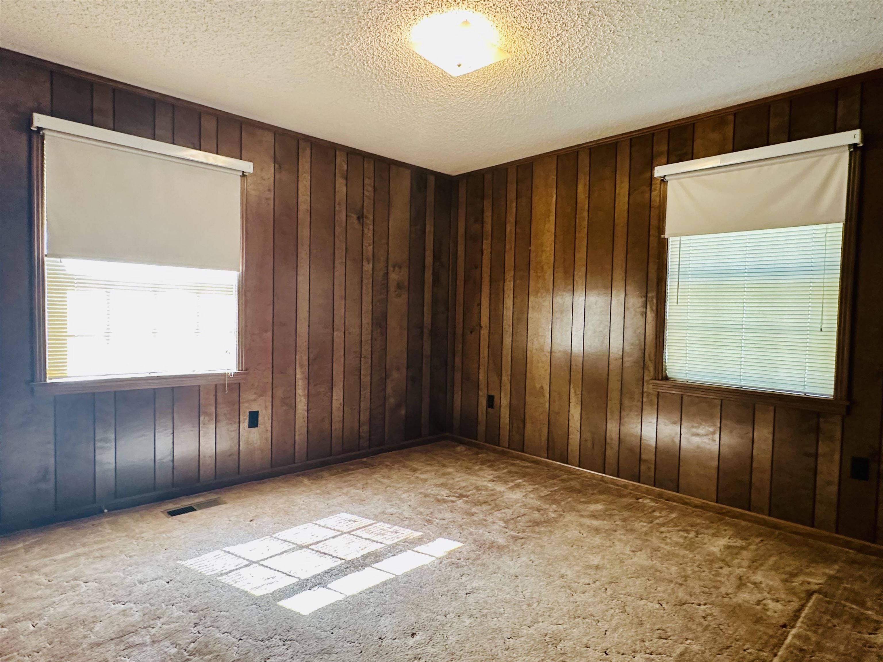 182 Wenasoga Road Ramer, TN 38367 - Photo 16 of 31 an empty room with wooden floor and windows