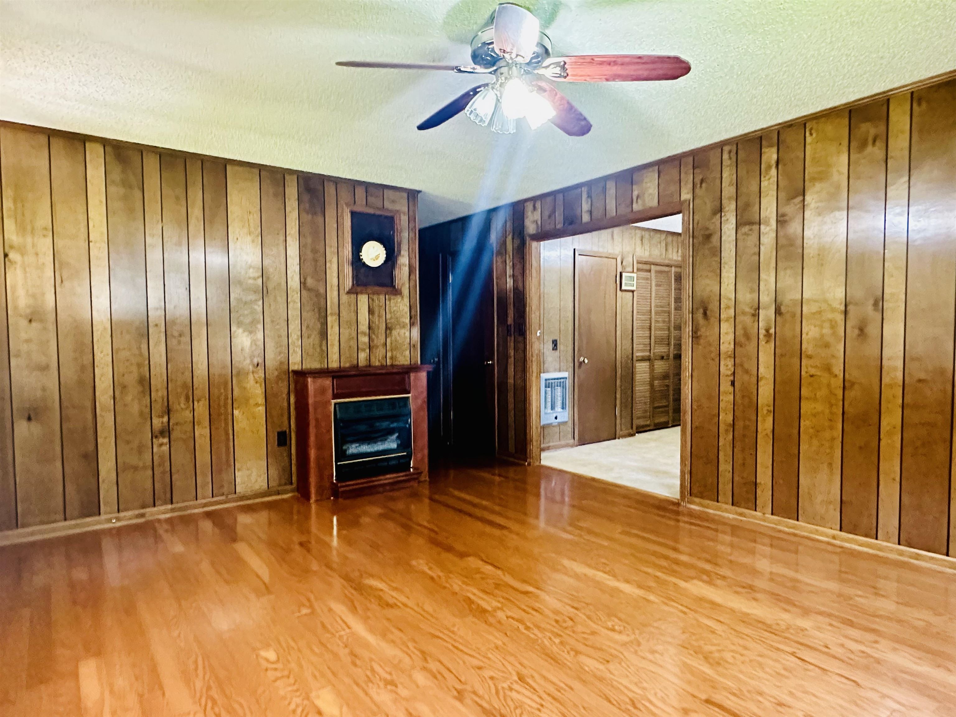 182 Wenasoga Road Ramer, TN 38367 - Photo 3 of 31 a view of empty room with wooden floor and ceiling fan