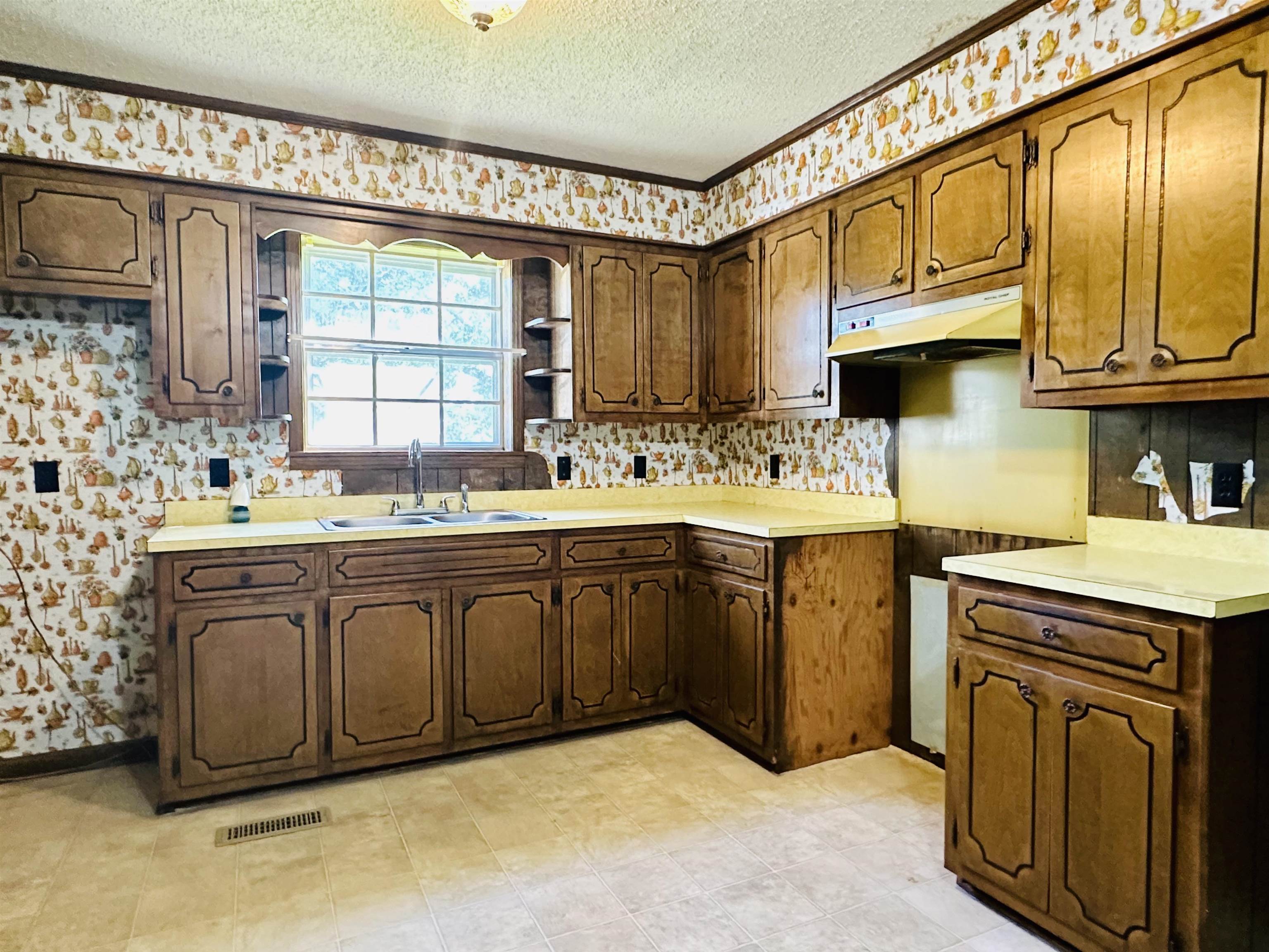 182 Wenasoga Road Ramer, TN 38367 - Photo 8 of 31 a kitchen with a sink cabinets appliances and a window