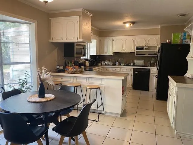 a kitchen with a dining table and chairs
