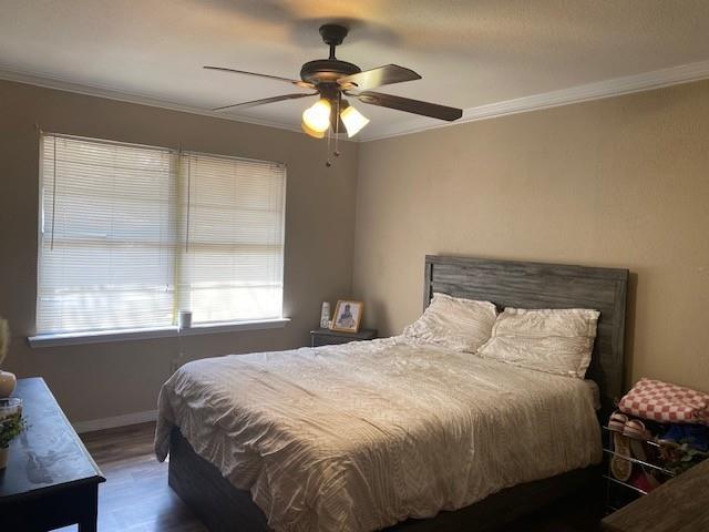 533 East Bryson Avenue Athens, TX 75751 - Photo 5 of 6 a bedroom with a bed and a chandelier