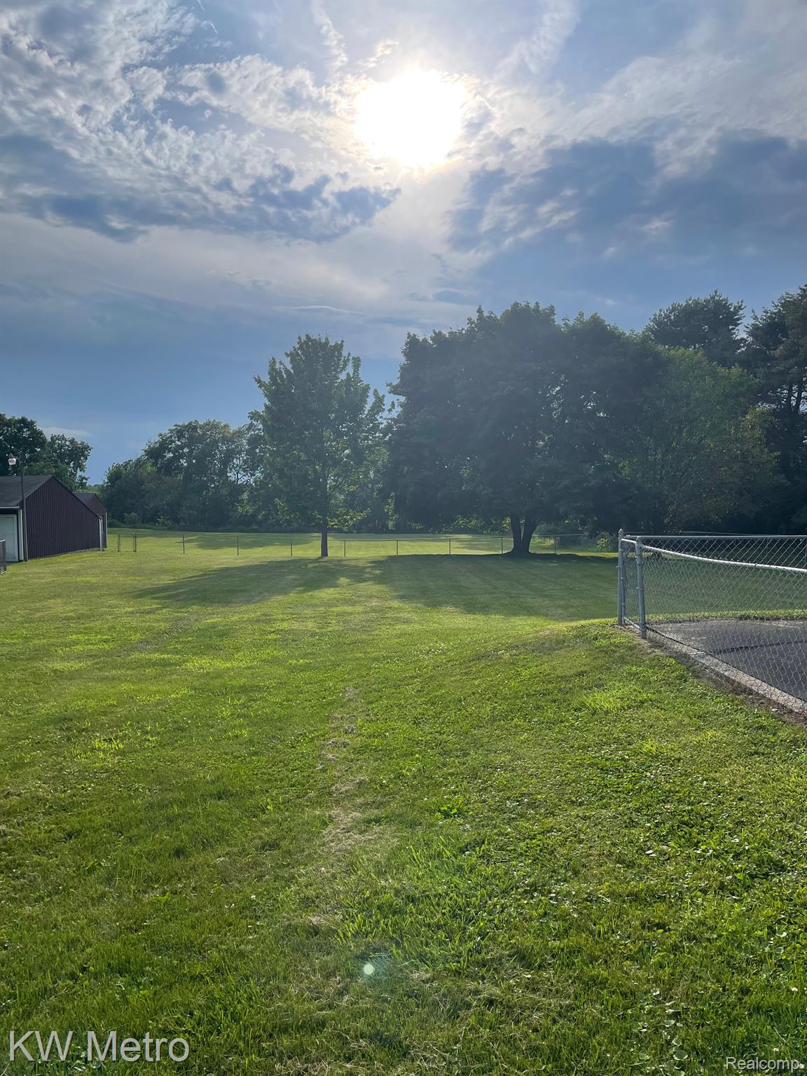 7924 South Vernon Road Durand, MI 48429 - Photo 3 of 12 Back yard extends past fence back to tree line