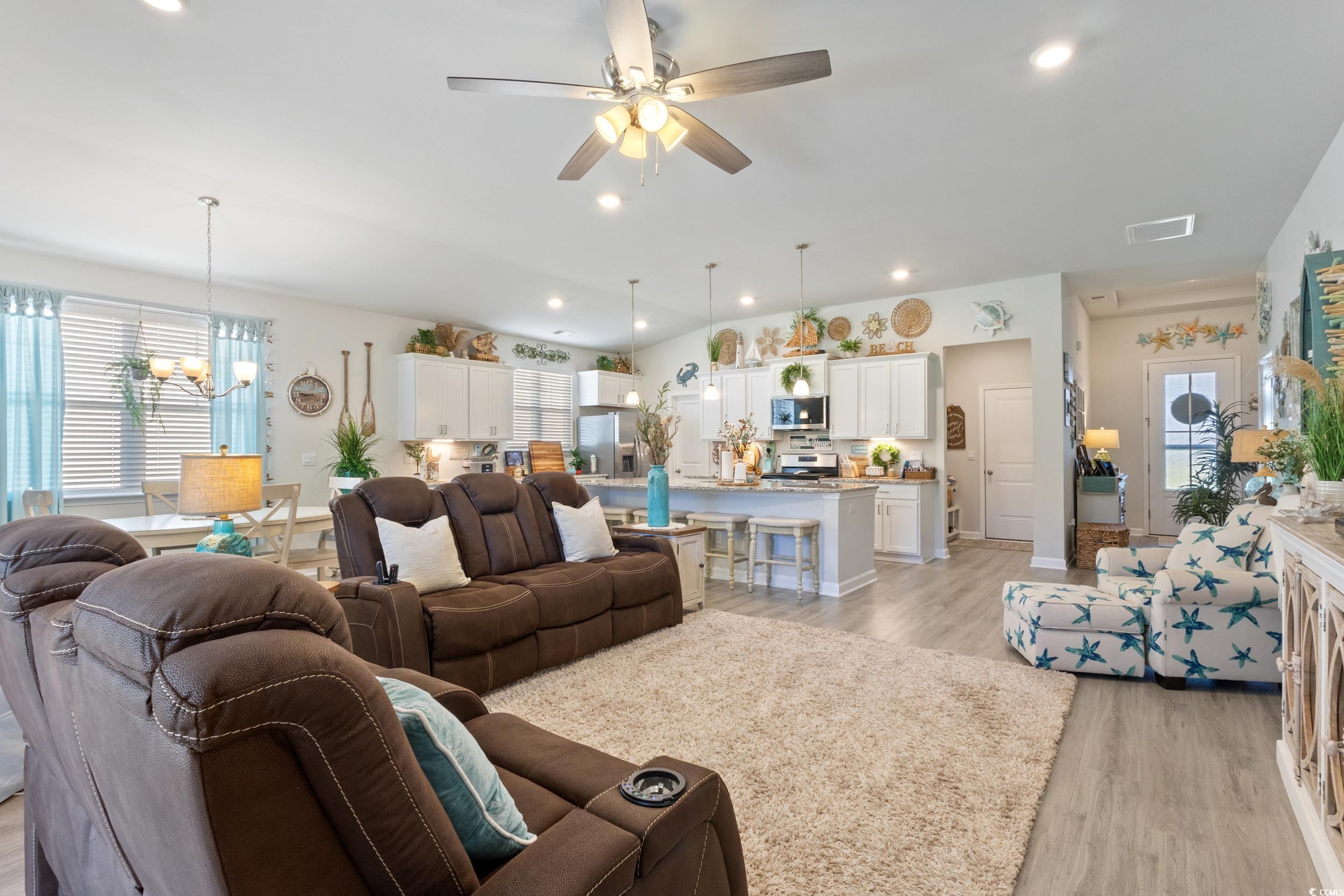6037 Mcclain Court Little River, SC 29566 - Photo 11 of 39 Living room with light wood finished floors, recessed lighting, a ceiling fan, and a chandelier