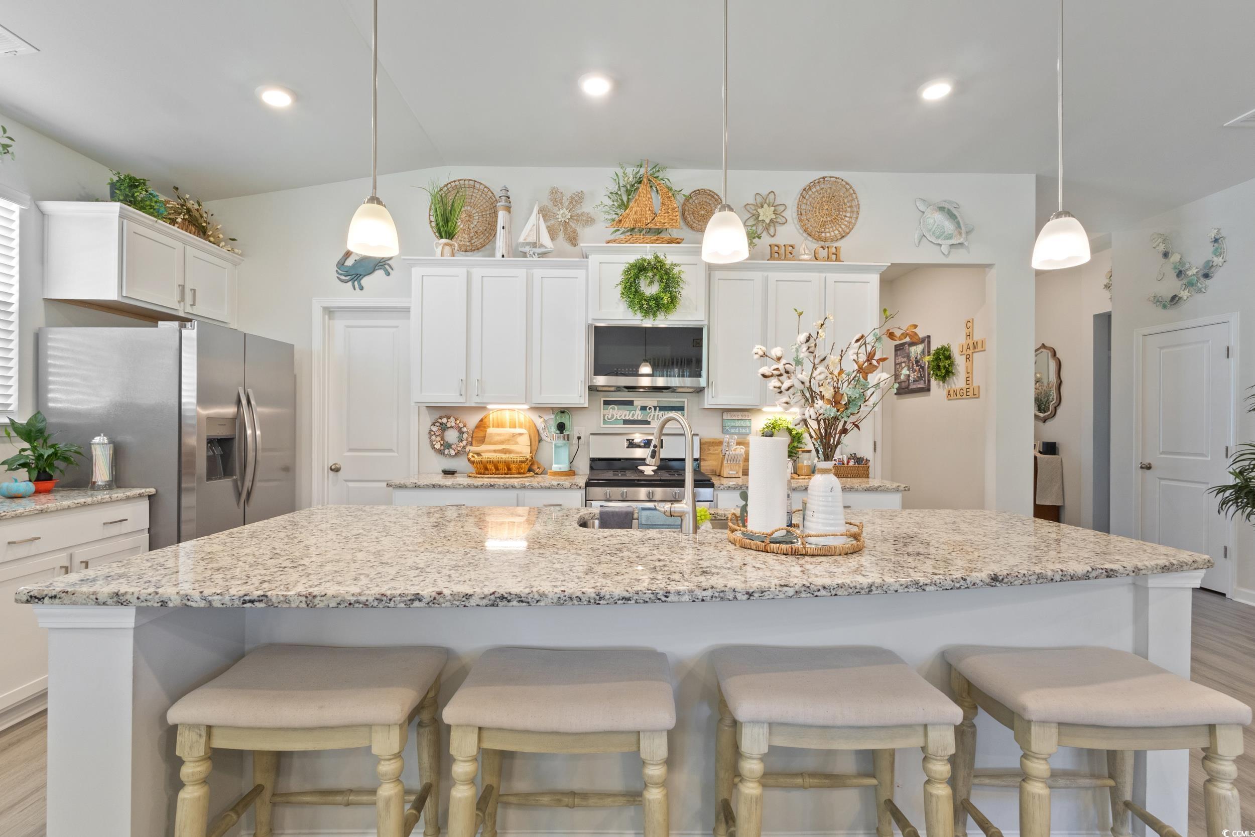6037 Mcclain Court Little River, SC 29566 - Photo 16 of 39 Kitchen featuring white cabinetry, light wood finished floors, pendant lighting, stainless steel appliances, and recessed lighting