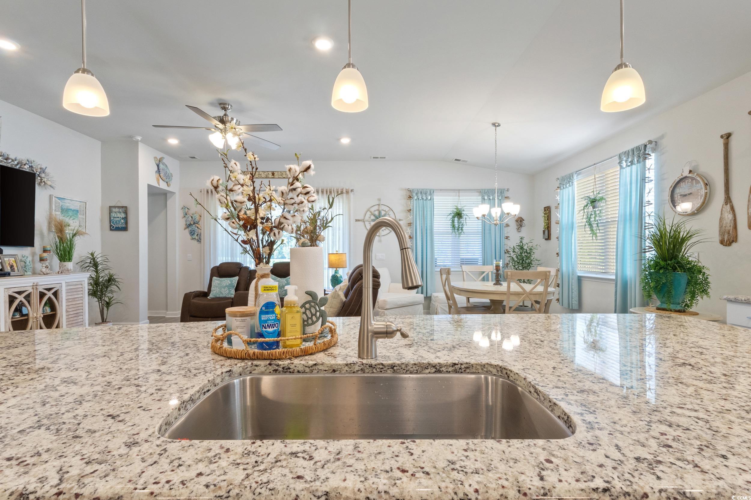 6037 Mcclain Court Little River, SC 29566 - Photo 38 of 39 Kitchen featuring open floor plan, light stone countertops, hanging light fixtures, ceiling fan, and vaulted ceiling