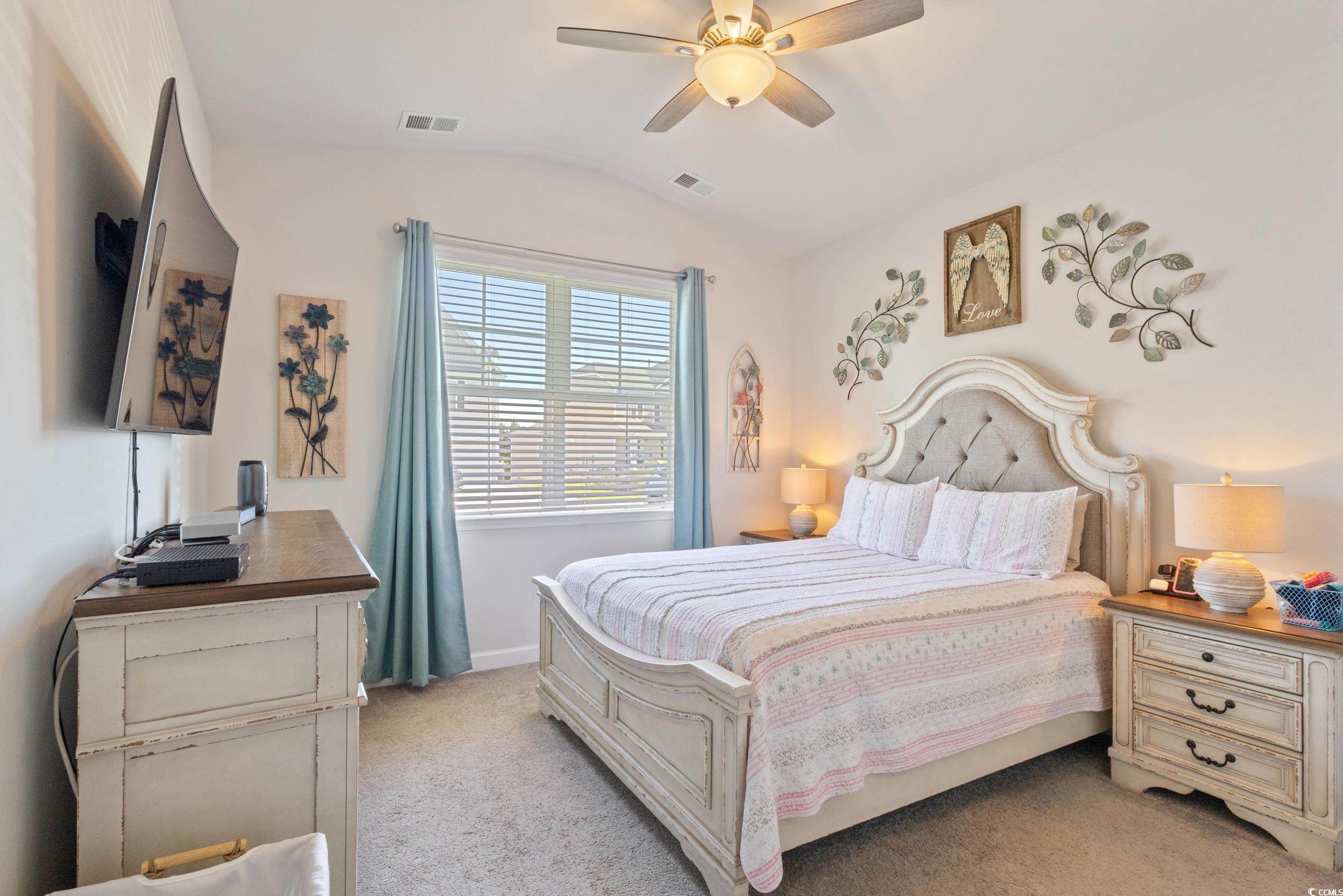 6037 Mcclain Court Little River, SC 29566 - Photo 19 of 39 Bedroom featuring light carpet, lofted ceiling, and ceiling fan