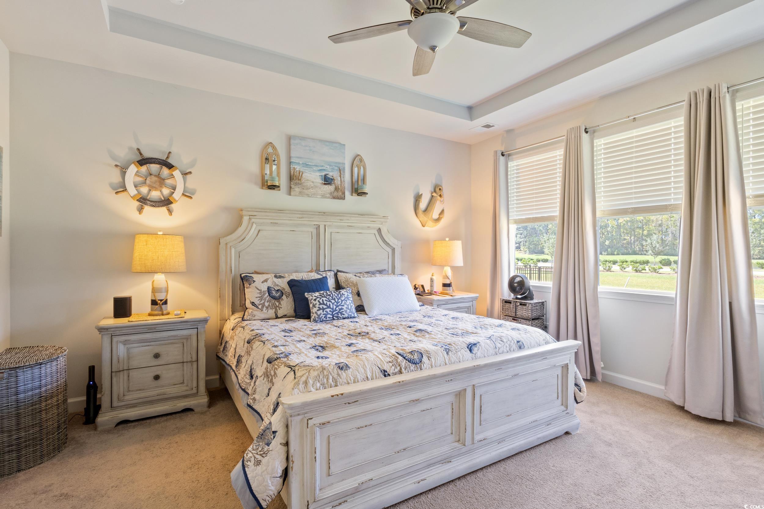 6037 Mcclain Court Little River, SC 29566 - Photo 21 of 39 Bedroom with light colored carpet, a raised ceiling, and a ceiling fan