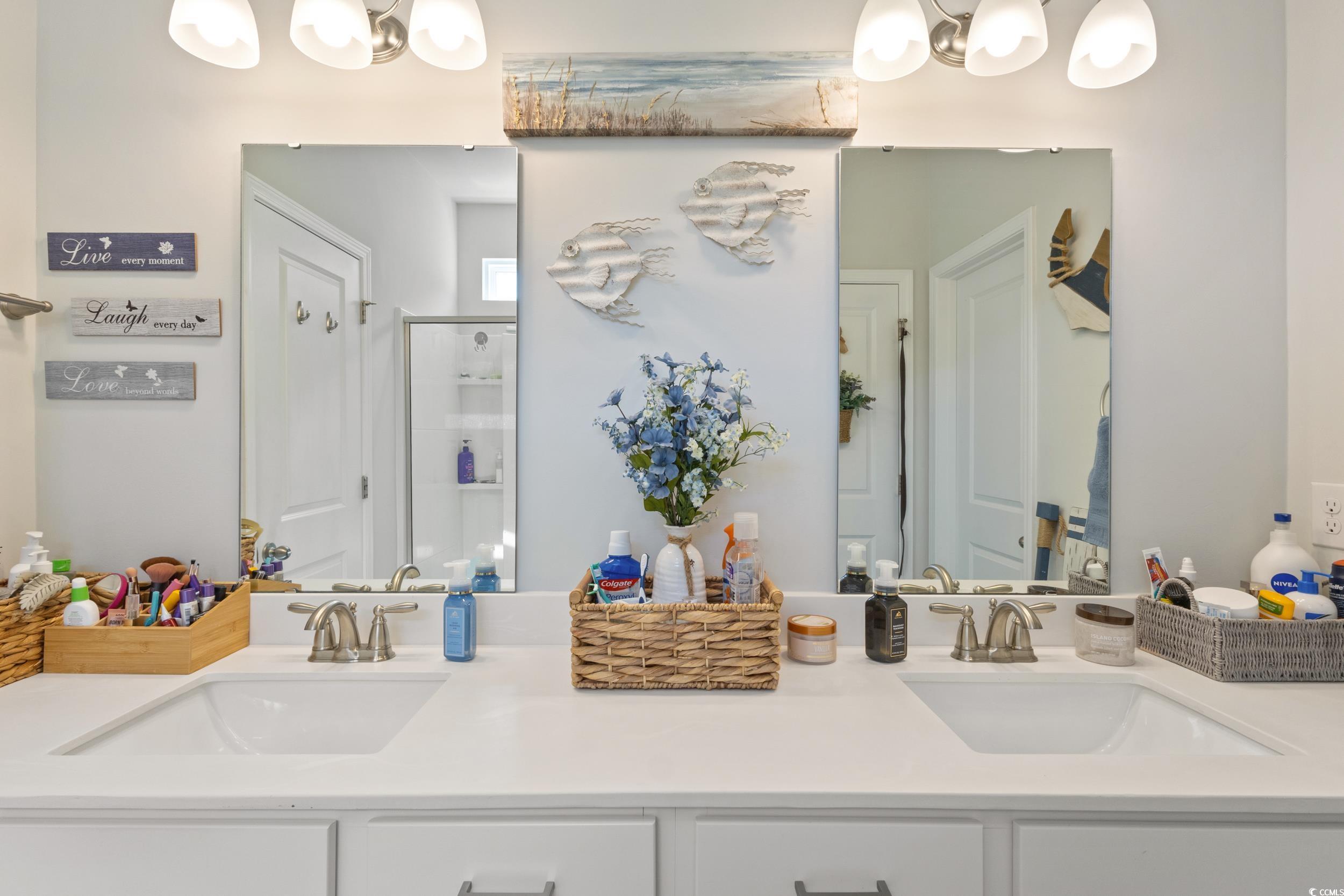 6037 Mcclain Court Little River, SC 29566 - Photo 24 of 39 Bathroom featuring a chandelier, a shower stall, and double vanity