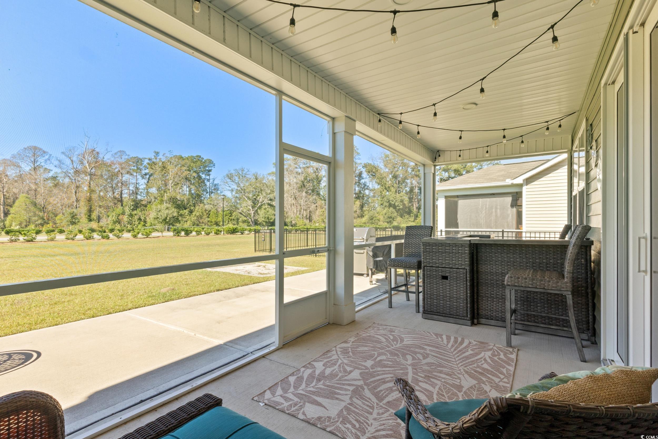 6037 Mcclain Court Little River, SC 29566 - Photo 29 of 39 Sunroom / solarium with view of wooded area