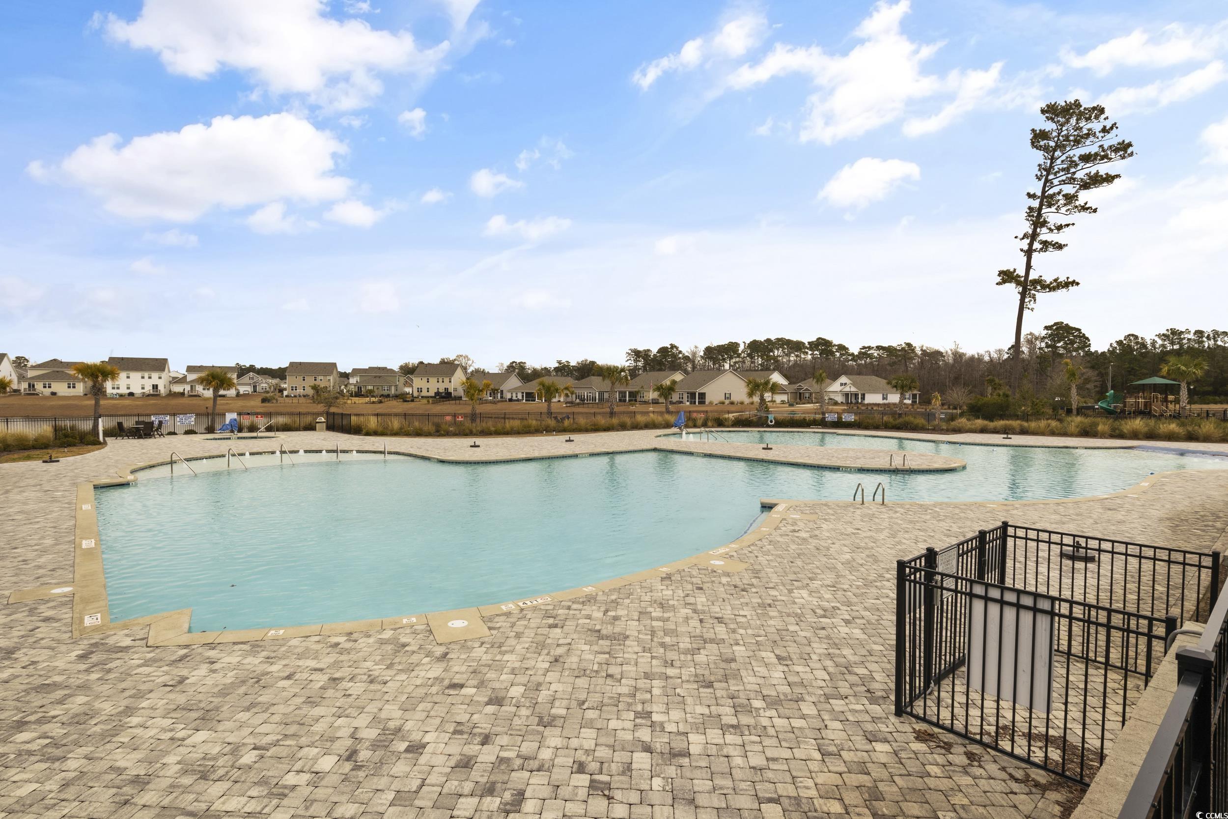 6037 Mcclain Court Little River, SC 29566 - Photo 31 of 39 Community pool featuring a patio and a residential view