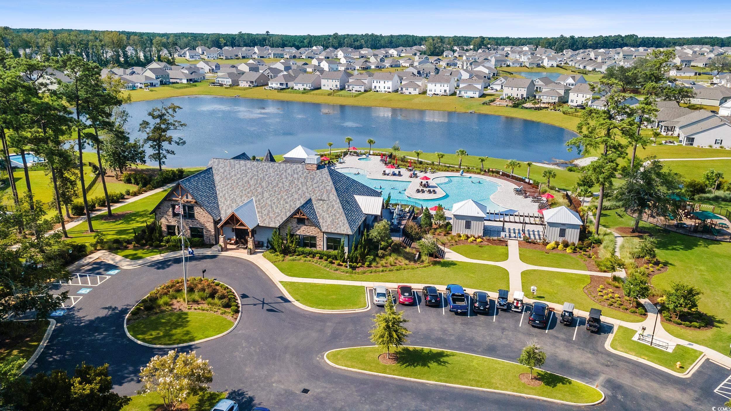 6037 Mcclain Court Little River, SC 29566 - Photo 33 of 39 Aerial perspective of suburban area with a large body of water and a pool