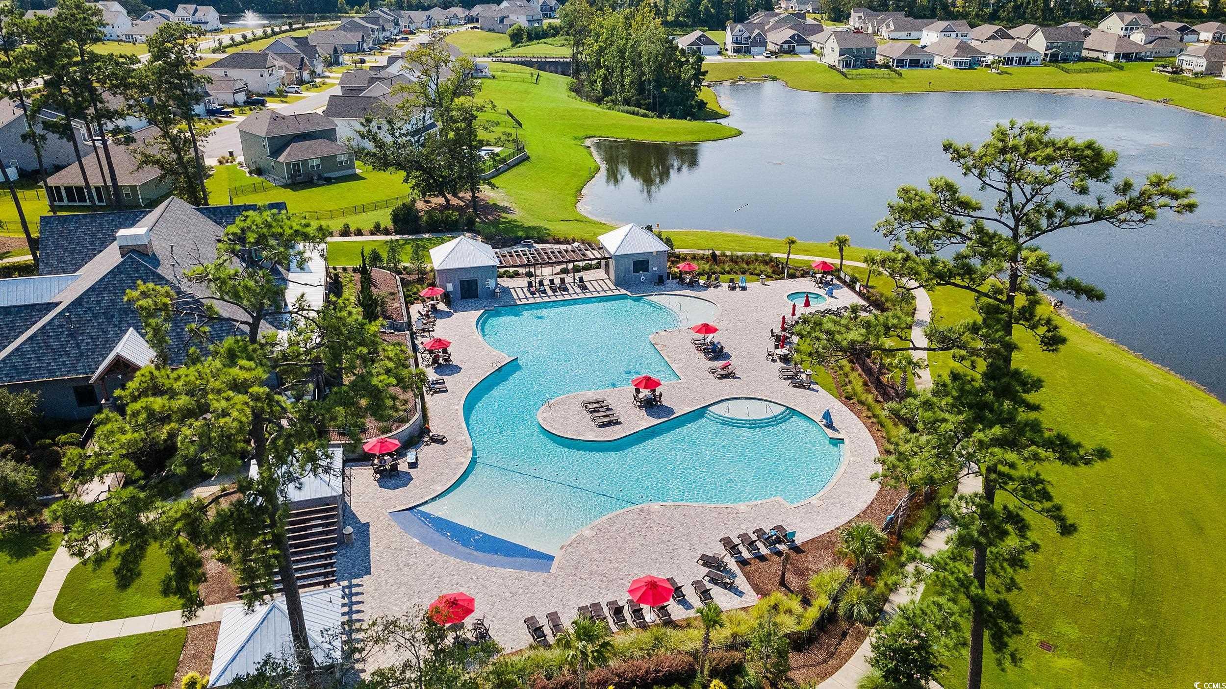 6037 Mcclain Court Little River, SC 29566 - Photo 35 of 39 Aerial perspective of suburban area featuring a nearby body of water and a pool area