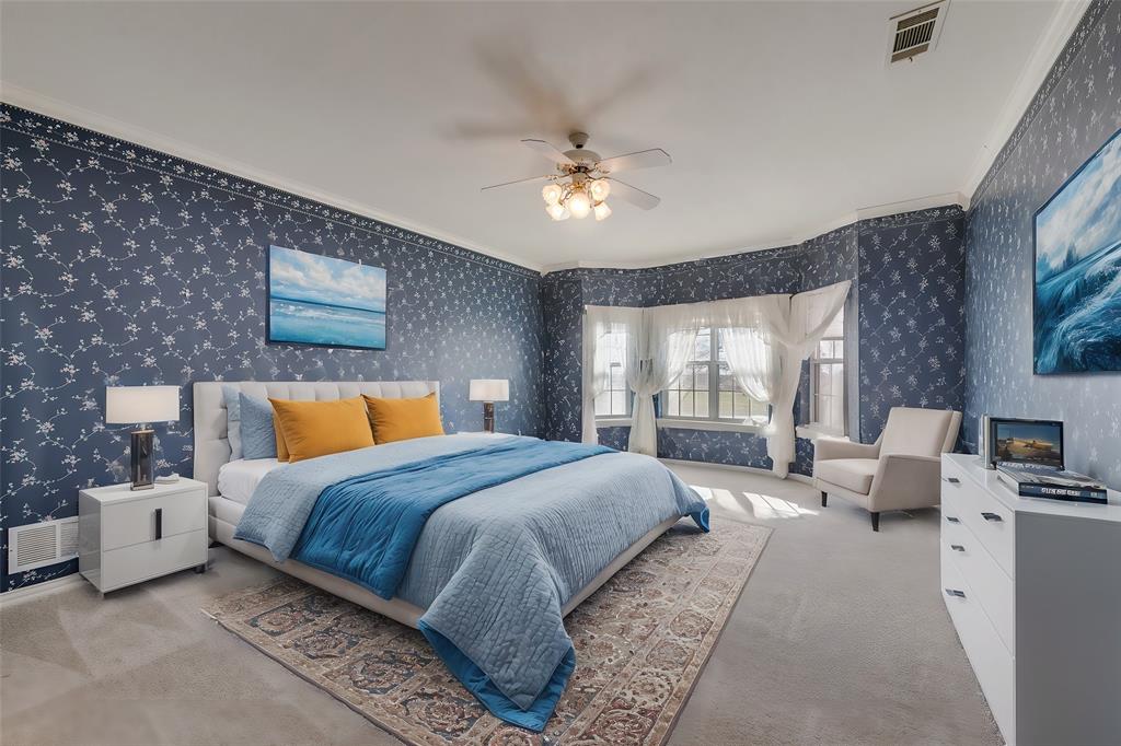 2251 English Road Rockwall, TX 75032 - Photo 23 of 36 a bedroom with a large bed and a chandelier