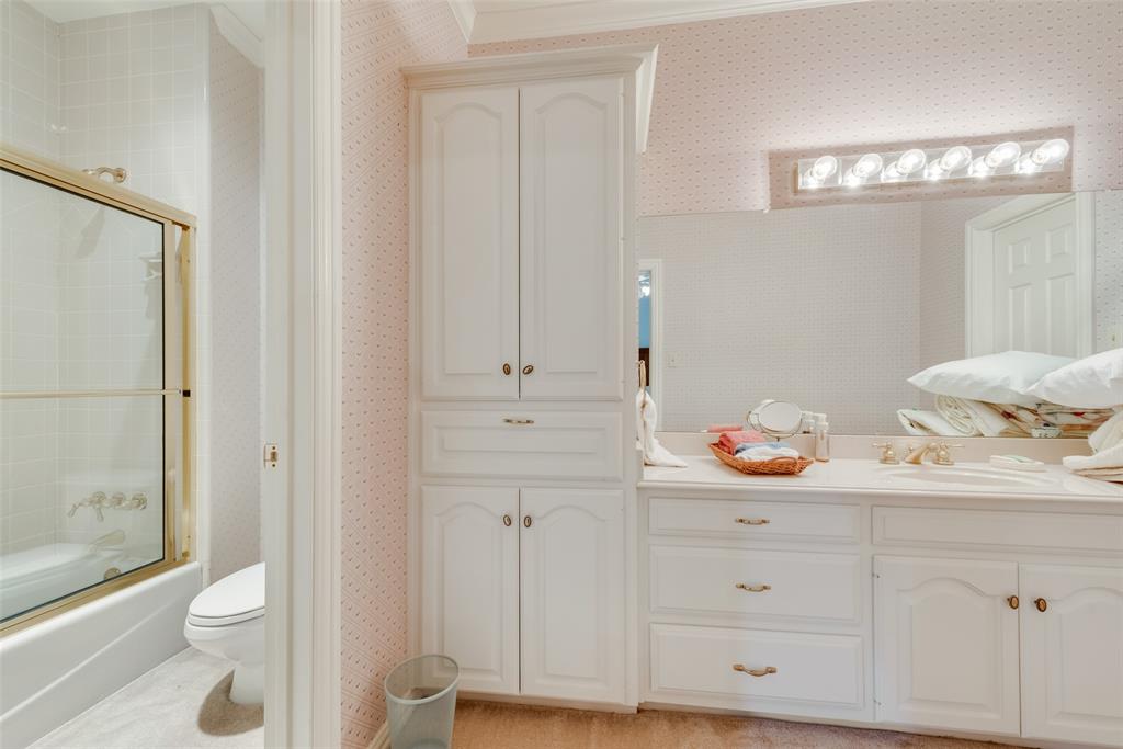 2251 English Road Rockwall, TX 75032 - Photo 24 of 36 a bathroom with a sink a toilet and a shower