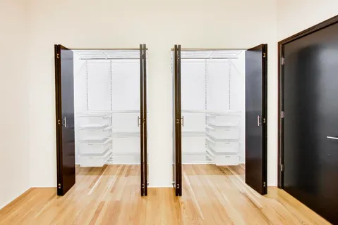 a view of a room with wooden floor and door