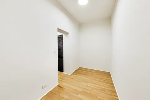 a view of a room with wooden floor