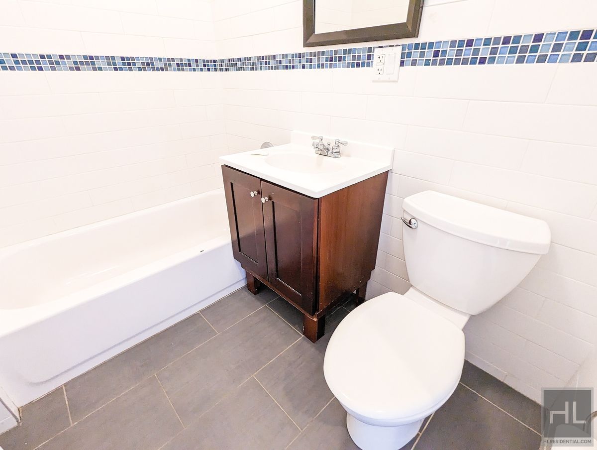 1143 Dekalb Avenue, Unit 4G Brooklyn, NY 11221 - Photo 6 of 7 a bathroom with a toilet and a sink
