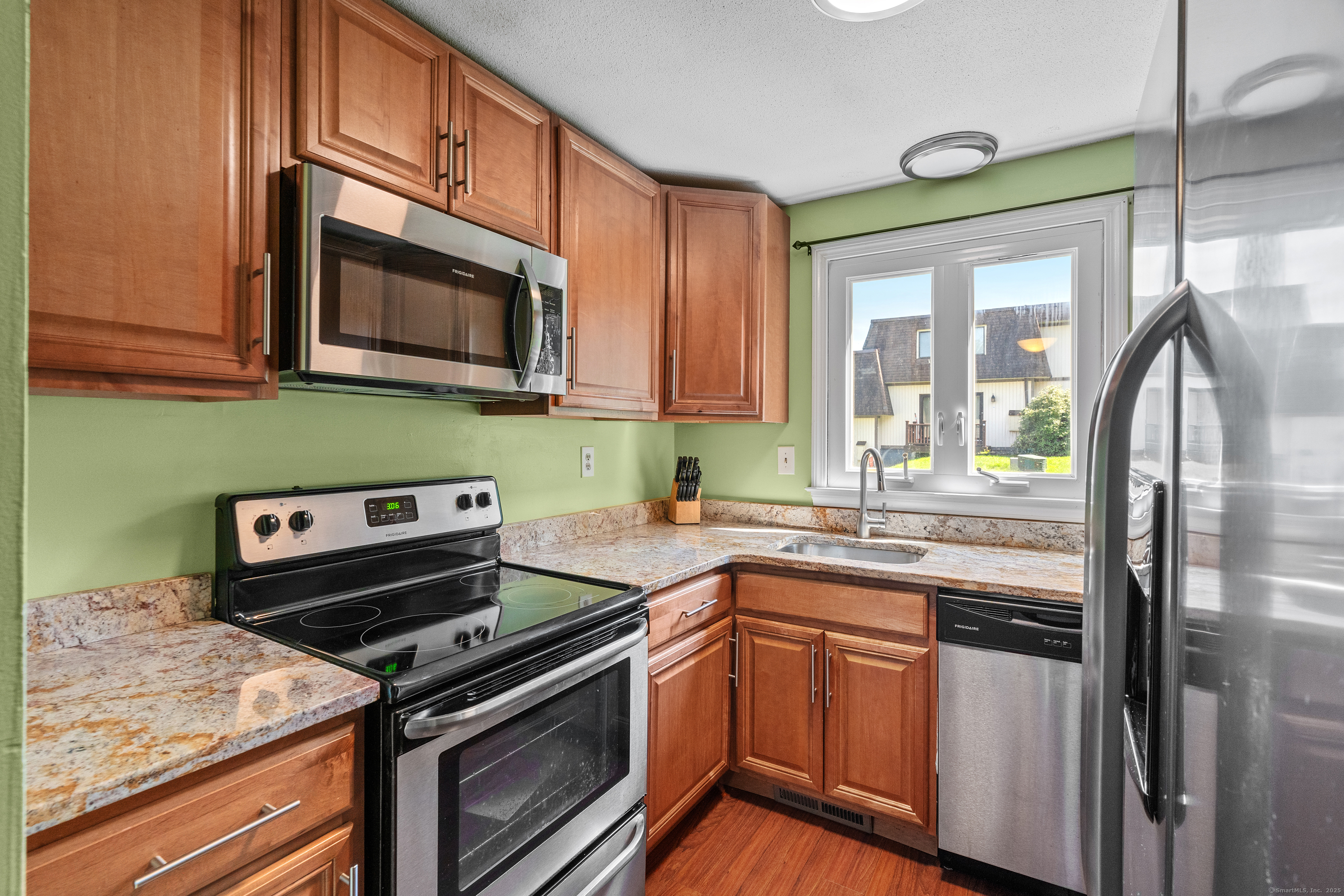 Pretty kitchen with granite counters and stainless appliances.