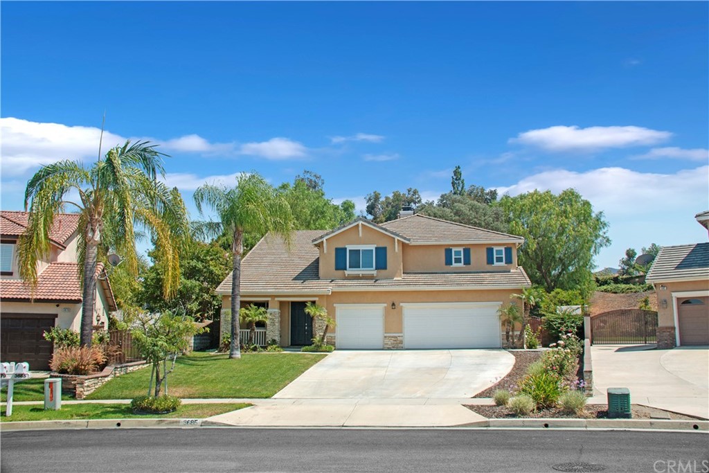 3685 Sedlock Drive Corona, CA 92881 - Photo 1 of 34 a front view of a house with a yard and trees
