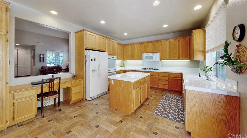 3685 Sedlock Drive Corona, CA 92881 - Photo 12 of 34 a kitchen with stainless steel appliances granite countertop a sink a stove a refrigerator a washer and dryer