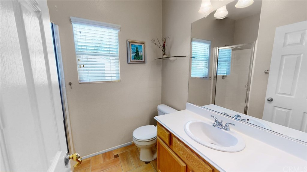 3685 Sedlock Drive Corona, CA 92881 - Photo 13 of 34 a bathroom with a sink toilet and mirror