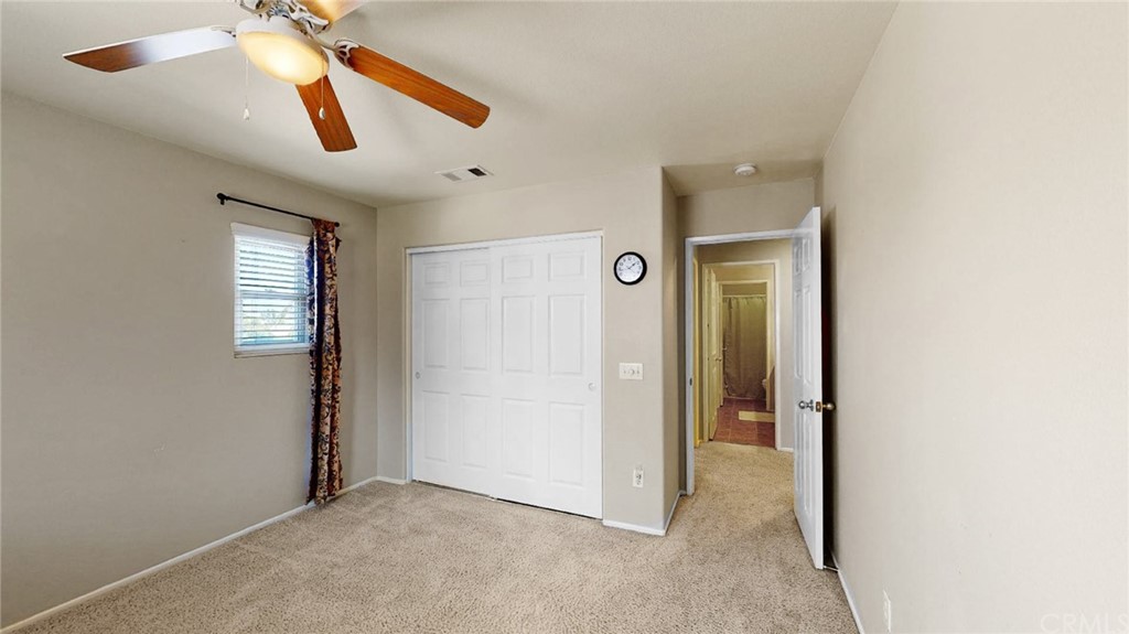 3685 Sedlock Drive Corona, CA 92881 - Photo 27 of 34 an empty room with closet and a ceiling fan