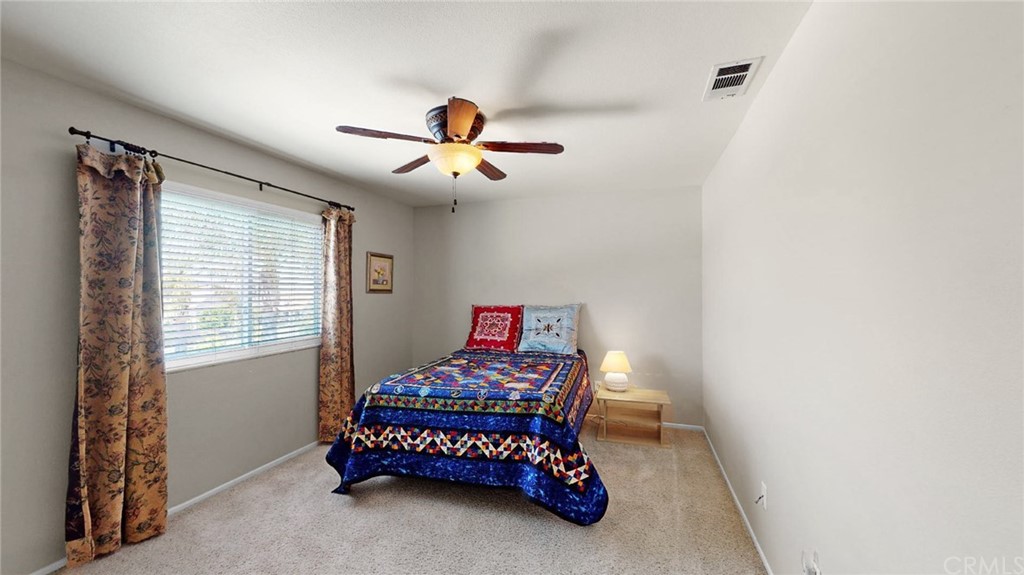 3685 Sedlock Drive Corona, CA 92881 - Photo 28 of 34 a bedroom with a bed and a chandelier