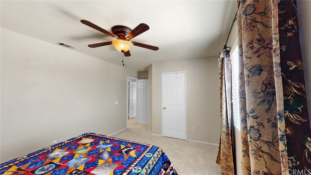 3685 Sedlock Drive Corona, CA 92881 - Photo 29 of 34 a bedroom with a bed and a chandelier