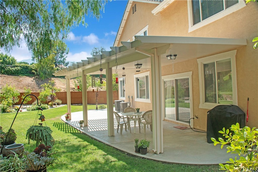 3685 Sedlock Drive Corona, CA 92881 - Photo 30 of 34 a view of a patio with table and chairs and potted plants