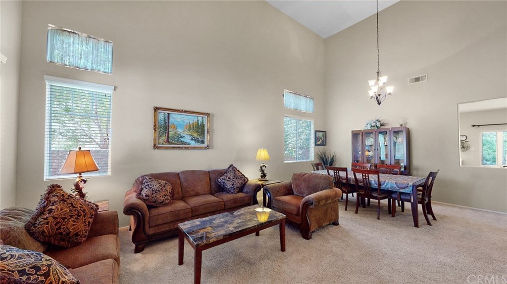 3685 Sedlock Drive Corona, CA 92881 - Photo 5 of 34 a living room with furniture a dining table and a window