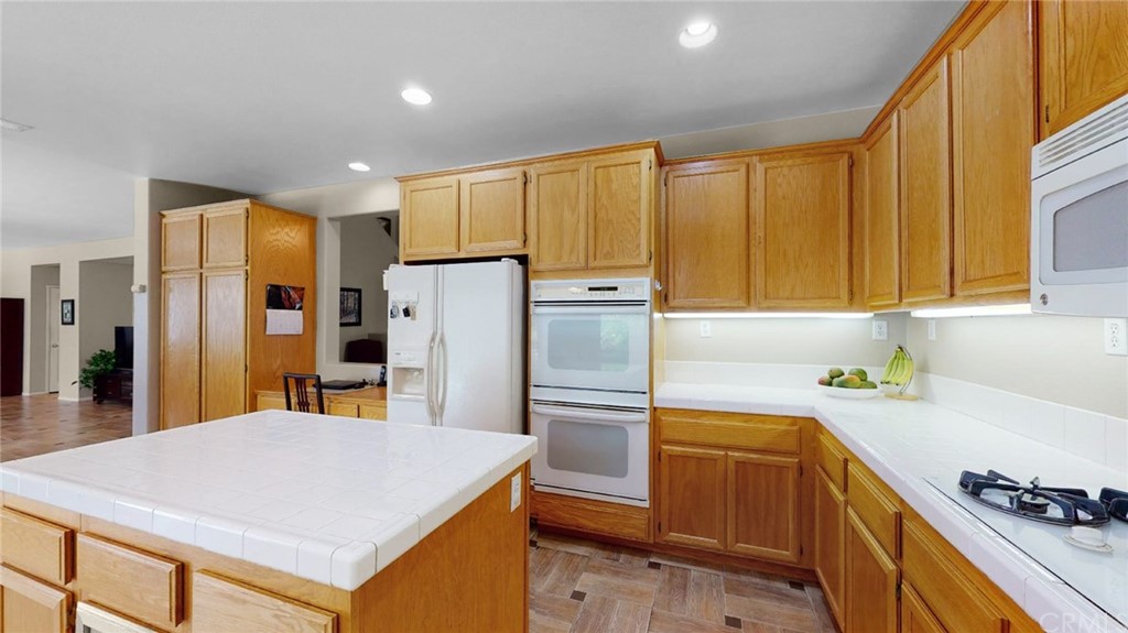 3685 Sedlock Drive Corona, CA 92881 - Photo 10 of 34 a kitchen with a refrigerator a sink and cabinets