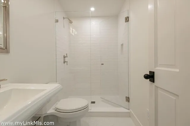 a bathroom with a toilet and shower