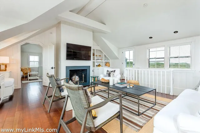 a living room with patio furniture and a fireplace