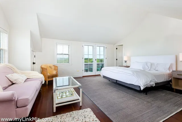 a bedroom with a bed window and couch