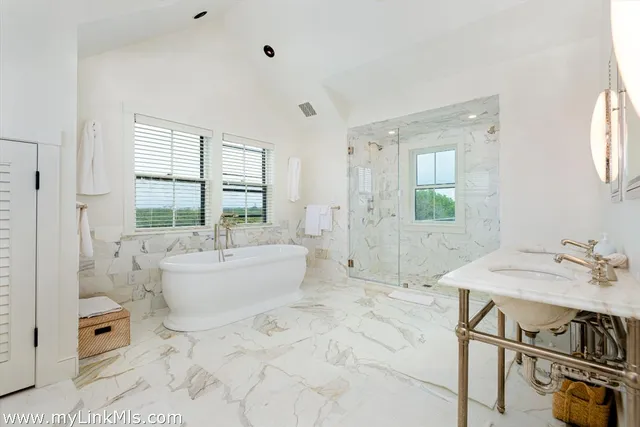 a spacious bathroom with sink shower and bathtub