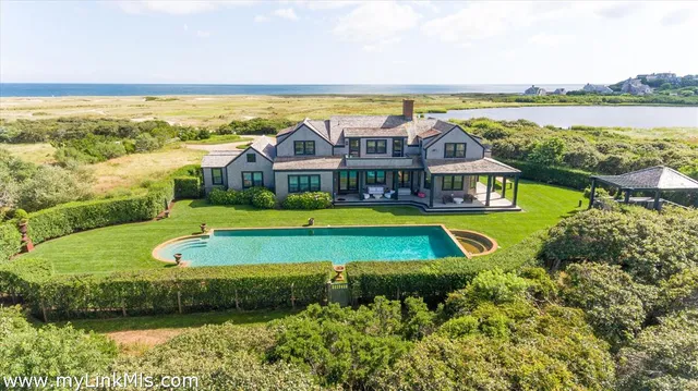 an aerial view of a house with a swimming pool and outdoor space