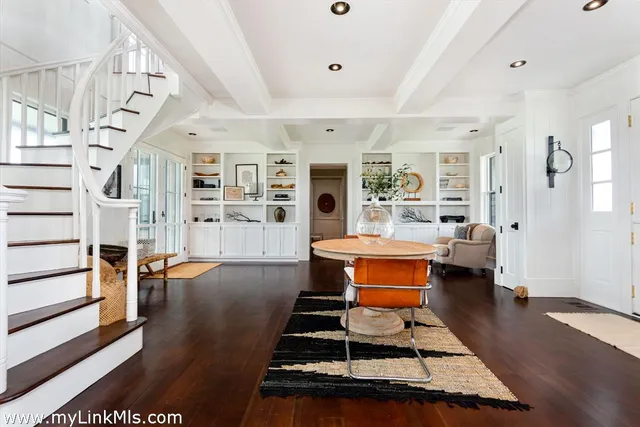 a room with lots of wooden furniture and wooden floors
