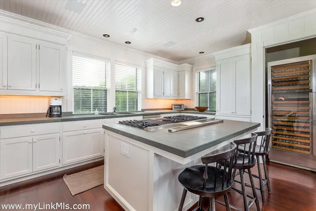 a kitchen with a stove a sink and a refrigerator
