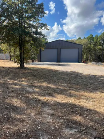 a front view of house with yard and trees